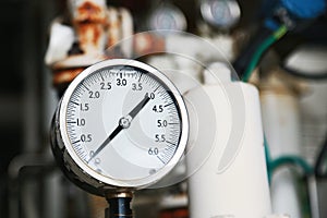 Pressure gauge using measure the pressure in production process. Worker or Operator monitoring oil and gas process by the gauge