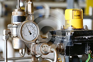 Pressure gauge using measure the pressure in production process. Worker or Operator monitoring oil and gas process by the gauge