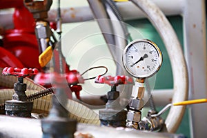 Pressure gauge using measure the pressure in production process. Worker or Operator monitoring oil and gas process by the gauge