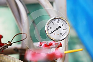 Pressure gauge using measure the pressure in production process. Worker or Operator monitoring oil and gas process by the gauge