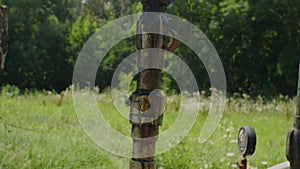 Pressure gauges and oil-stained pipeline pipes. The work of an oil pump in an oil field. The concept of environmental pollution