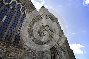 Presteigne church window, tower and yew tree in Powys, Wales. photo