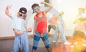 Preteen african boy and european girl hip hop dancers during group class