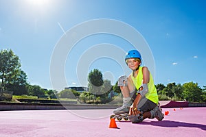 Preteen boy at city skate park pose with rollerblades