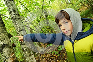 Preteen boy close up portrait in the autumn forest