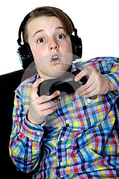 Preteen boy with an excited expression playing a video game hold