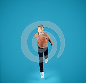 Preteen Boy Jumping In Air And Looking At Camera