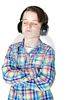 Preteen boy listening to music with headphones with eyes closed