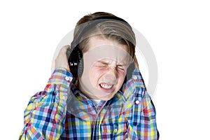 Preteen boy listening to music with headphones and an intense fa