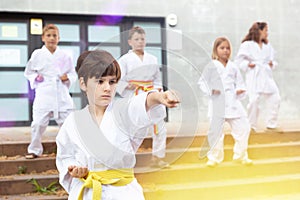 Preteen boy practicing karate at schoolyard