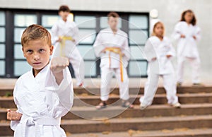 Preteen boy practicing karate at schoolyard