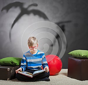 Preteen boy reading a book