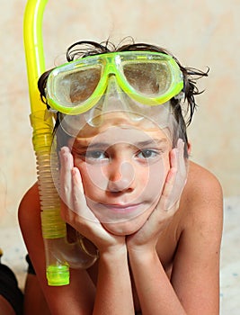 Preteen boy in snorkeling mask and tube