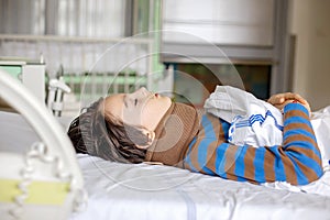 Preteen child, boy, lying in hospital with fractured thoracic spine, vertebralis