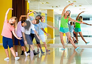 Preteen dancers practicing dance routine with female choreograph photo
