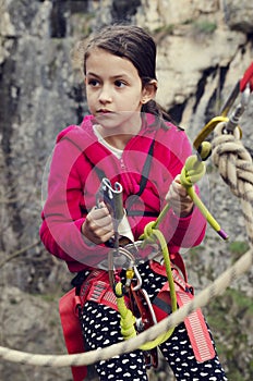 Preteen girl with climbing equipment. Adventure. Sport activity.