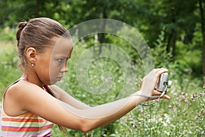 Preteen girl with digital camera