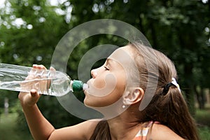 Preteen girl drinking watter photo