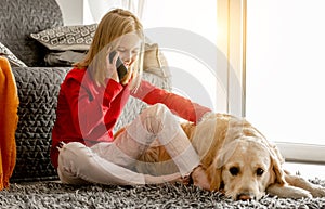 Preteen girl with golden retriever dog