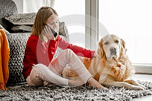 Preteen girl with golden retriever dog