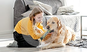 Preteen girl with golden retriever dog