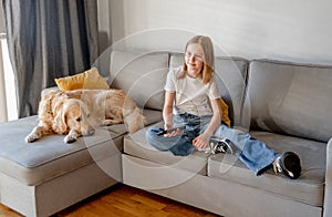 Preteen girl with golden retriever at home