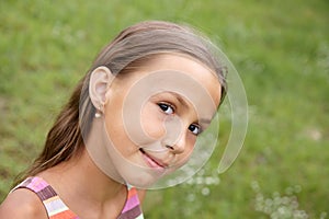 Preteen girl on grass background