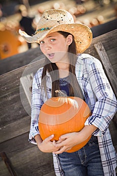 Preteen Girl Having Fun at the Pumpkin Patch