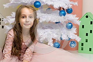 Preteen Girl Posing in Front of Decorated White Christmas Tree