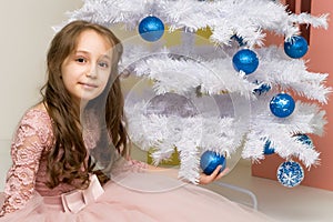 Preteen Girl Posing in Front of Decorated White Christmas Tree