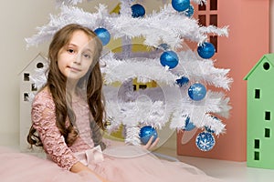 Preteen Girl Posing in Front of Decorated White Christmas Tree