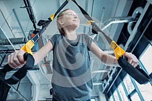 Preteen girl training with resistance bands in fitness class