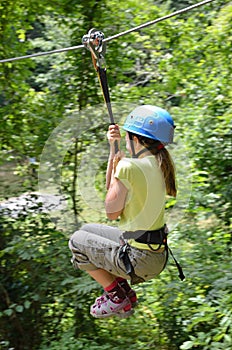 Preteen girl zipping down