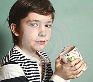 Preteen handsome boy drink milk with mustache