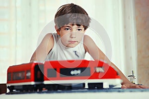 Preteen handsome boy play with meccano toy train