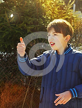 Preteen handsome boy toss a coin