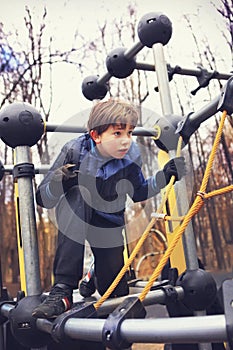 Preteen handsome boy train in outdoor gym training ground.