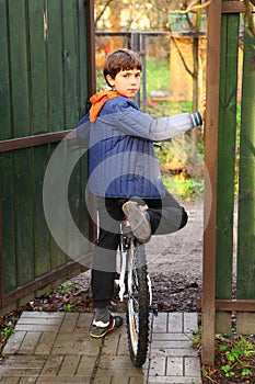 Preteen handsome country boy with bicycle ready to ride