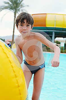 Preteen little boy in open air aqua park