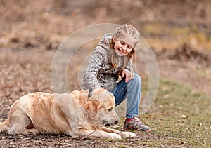 Preteen girl with golden retriever dog