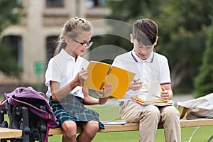 Preteen multiethnic schoolkids holding notebooks 