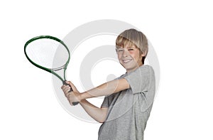 Preteen playing tennis holding racket