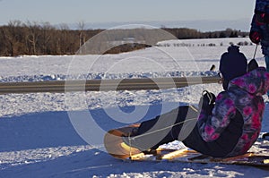 Preteen tobogganing in front lawn photo