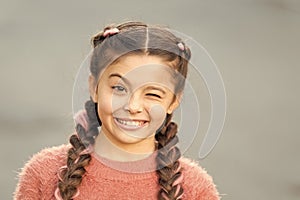 Pretend and joking. Playful child cheerful expression. Things gonna be alright. Girl wink cheerful face grey background