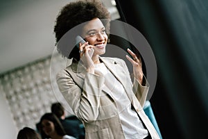 Pretty african american business woman talking on her mobile phone