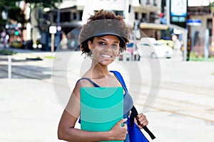 Pretty african american female student outdoor in city