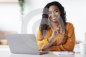 Pretty african american woman freelancer using laptop at home