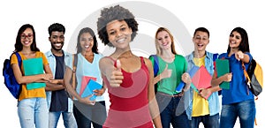 Pretty african american young adult woman with large group of international students