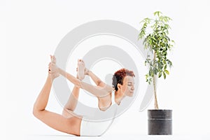 Pretty african american young woman exercising and practicing yoga