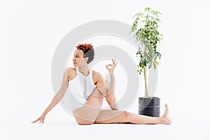 Pretty african american young woman relaxing and practicing yoga